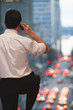 Caucasian businessman talking on cell phone and looking at traffic