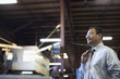 Hispanic foreman standing in factory