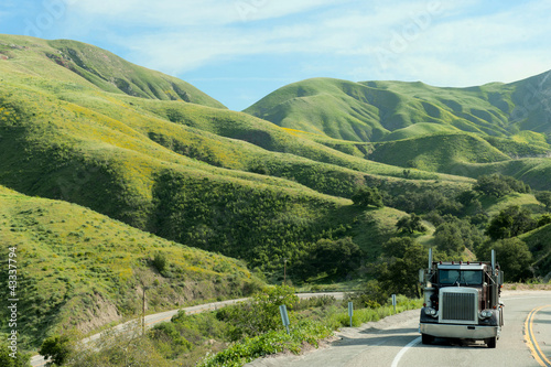 Photo: Semi-truck driving on remote highway Semi-truck driving on remote highway