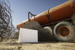 Blank placard next to abandoned tanker truck