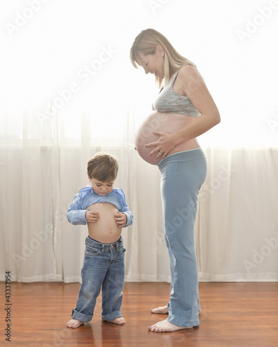 Photo: Caucasian boy imitating pregnant mother Caucasian boy imitating pregnant mother