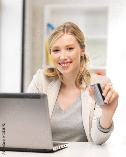 Photo: happy woman with laptop computer and credit card happy woman with laptop computer and credit card