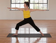 Hispanic woman practicing yoga on yoga mat