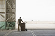 Caucasian worker with boxes in empty warehouse