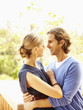 Glamorous Caucasian couple hugging outdoors