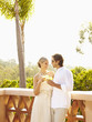 Glamorous Caucasian couple drinking cocktails outdoors