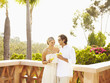 Glamorous Caucasian couple drinking cocktails outdoors