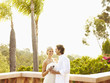 Glamorous Caucasian couple drinking red wine outdoors