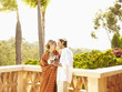 Glamorous Caucasian couple drinking red wine outdoors