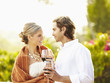 Glamorous Caucasian couple drinking red wine outdoors