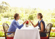 Glamorous Caucasian couple toasting in restaurant