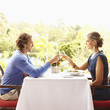 Glamorous Caucasian couple toasting in restaurant