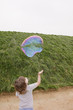 Caucasian boy looking at floating bubbles