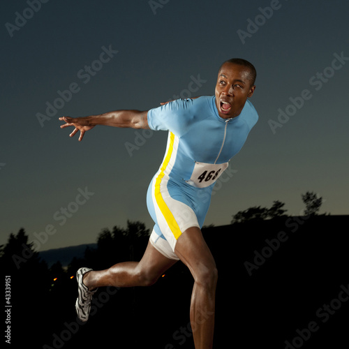 Photo: Black runner crossing finish line in race Black runner crossing finish line in race