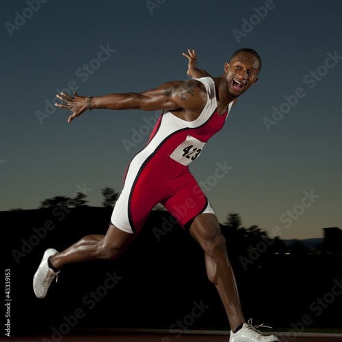 Photo: Black runner crossing finish line in race Black runner crossing finish line in race