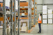 Manager holding clipboard in warehouse