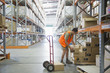 Worker stacking boxes in warehouse