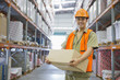 Worker holding box in warehouse