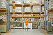 Worker looking at inventory in warehouse