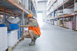 Worker using walkie talkie in warehouse