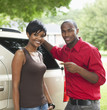African American couple with new car