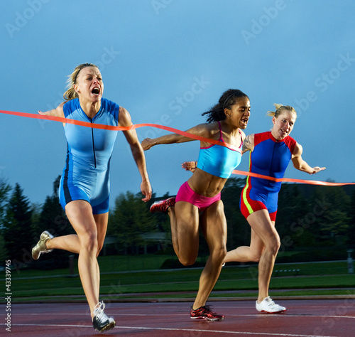 Photo: Runners crossing finish line in race Runners crossing finish line in race
