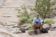 African American hiker taking a break in remote area
