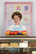 Black baker holding tray of cupcakes