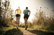 Caucasian couple running together on path