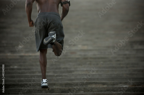 Photo: Black man running up stairs Black man running up stairs