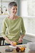 Senior woman cutting fruit