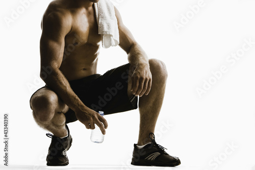 Photo: Caucasian man drinking water after exercise Caucasian man drinking water after exercise