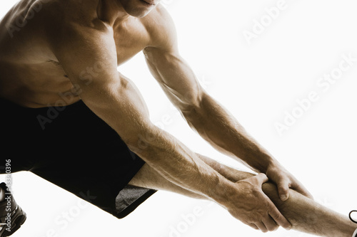 Photo: Caucasian man stretching before exercise Caucasian man stretching before exercise