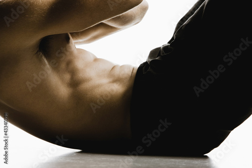 Photo: Caucasian man doing sit-ups Caucasian man doing sit-ups