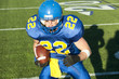 Caucasian football player running with ball