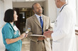 Doctors and drug salesman talking in hospital