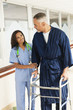 Photo: Nurse helping patient use walker in hospital Nurse helping patient use walker in hospital