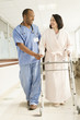 Photo: Nurse helping patient use walker in hospital Nurse helping patient use walker in hospital