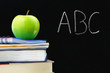 Photo: ABC written on a blackboard with books and apple in front ABC written on a blackboard with books and apple in front
