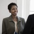 Black businesswoman talking to co-worker