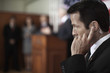 Security guard listening to earpiece at public speech