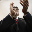 Hispanic businessman clapping