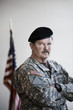 Soldier in uniform standing with arms crossed