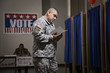 Hispanic soldier waiting to vote in polling place