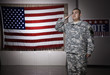 Hispanic soldier saluting American flag
