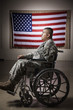Hispanic soldier in wheelchair near American flag