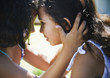Hispanic girl comforting her sister