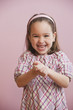 Grinning Caucasian girl with hands clasped