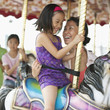 Mother and daughter riding carousel