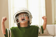 Cheering Caucasian boy in football uniform